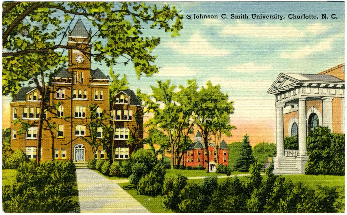 A colour-printed linen postcard captioned 'Johnson C. Smith University, Charlotte, N. C.', showing an illustrated view of a red brick building with a tall clock tower and steep slate roofs at the left, a white-columned portico on a brick building at the right, and clipped shrubs and paths between them.